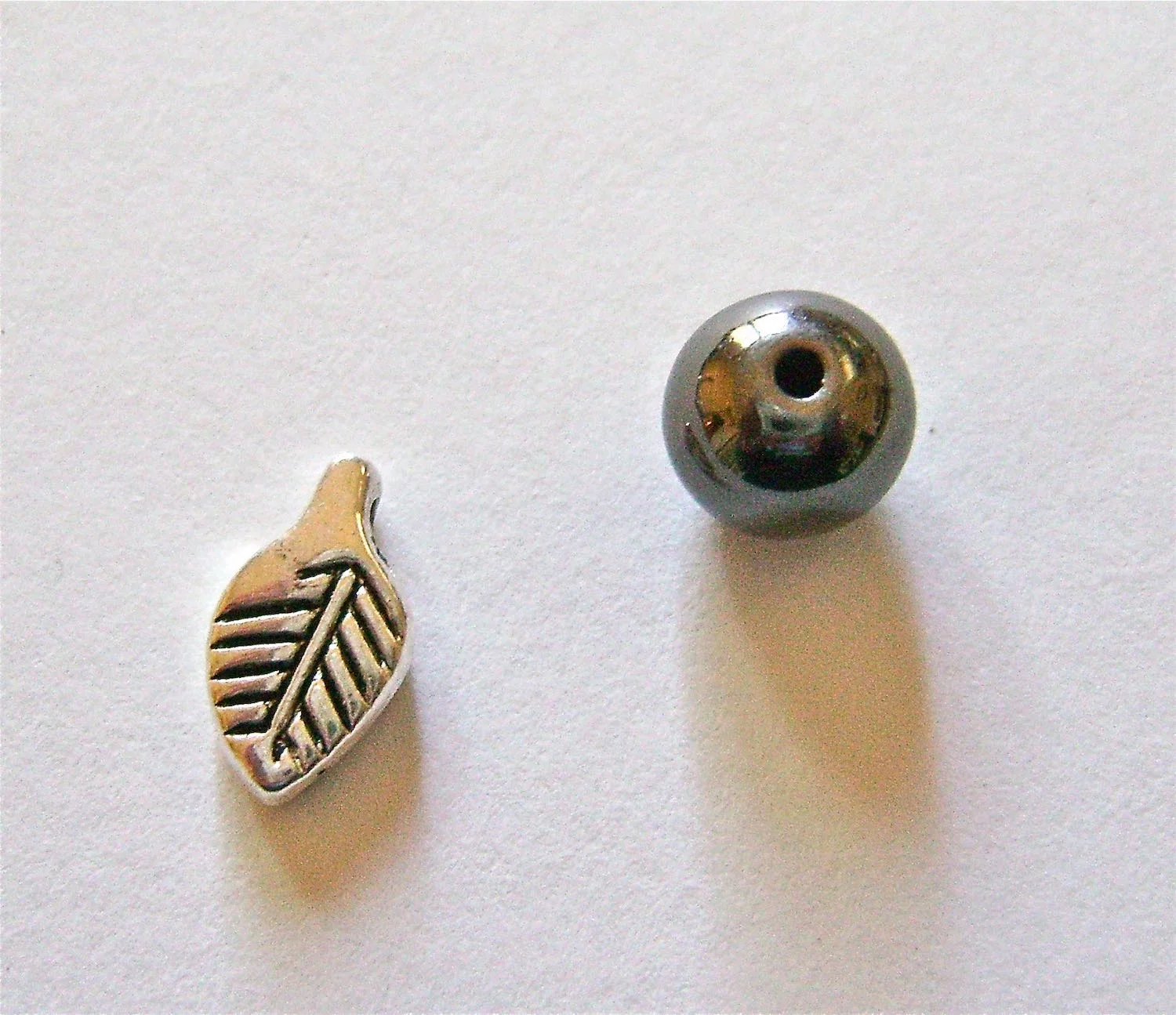 step 1 - The silver leaves measure 1/2” long. The gun metal beads are 8mm, but you can use slightly larger or smaller beads and not ruin the design.