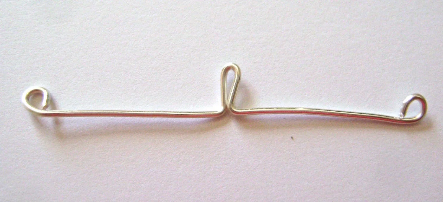 step 2 - Use round nose pliers to create a loop at the end of each wire. The loops should match in size.