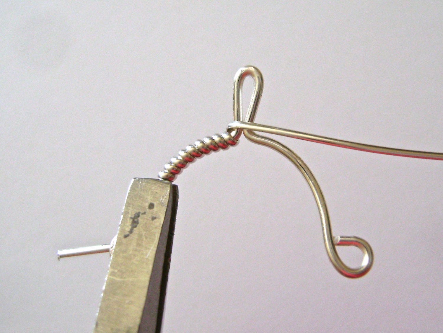 step 5 - Wrap the wire around the base of the center loop once.