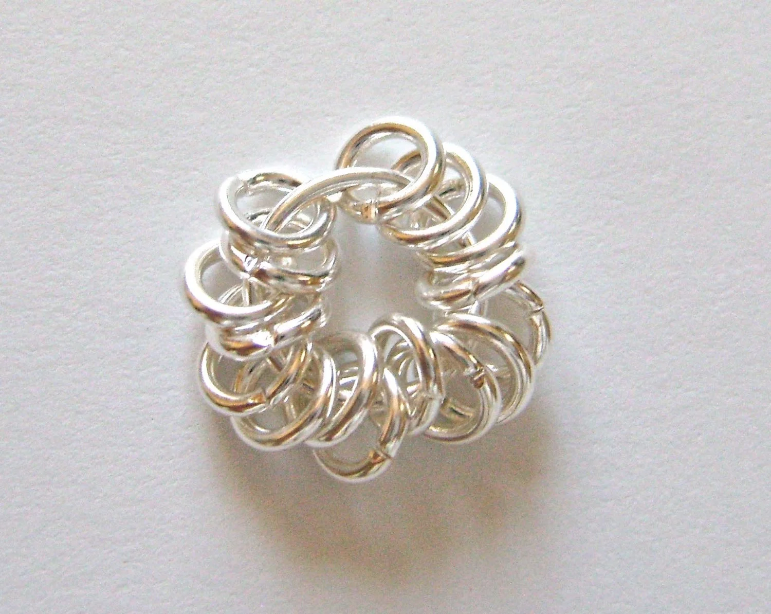 step 1 - Slip 16 closed 5mm jump rings onto a 10mm jump ring. 