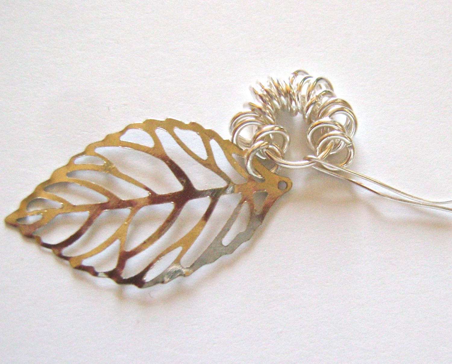 step 4 - Connect the jump ring attached to the leaf, to the 10mm ring and close it.