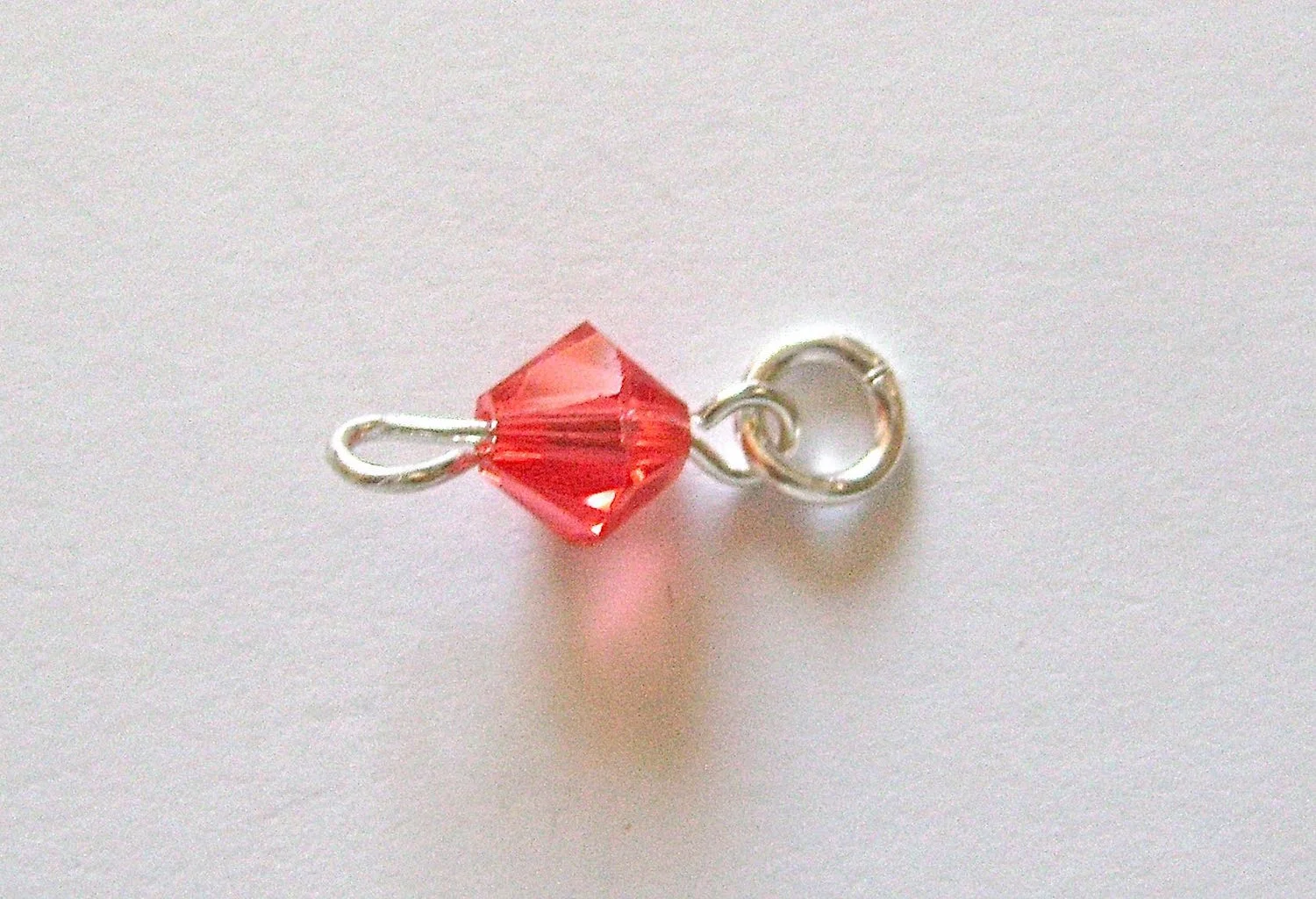 step 8 - Attach a 5mm jump ring to the end of the eye pin. Slip a crystal onto the pin and create a loop on the other end of the wire.