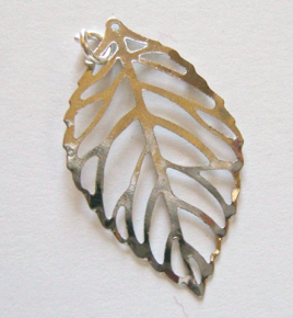 step 3 - Attach a 5mm jump ring to the top left opening in the leave. Don’t close the ring.