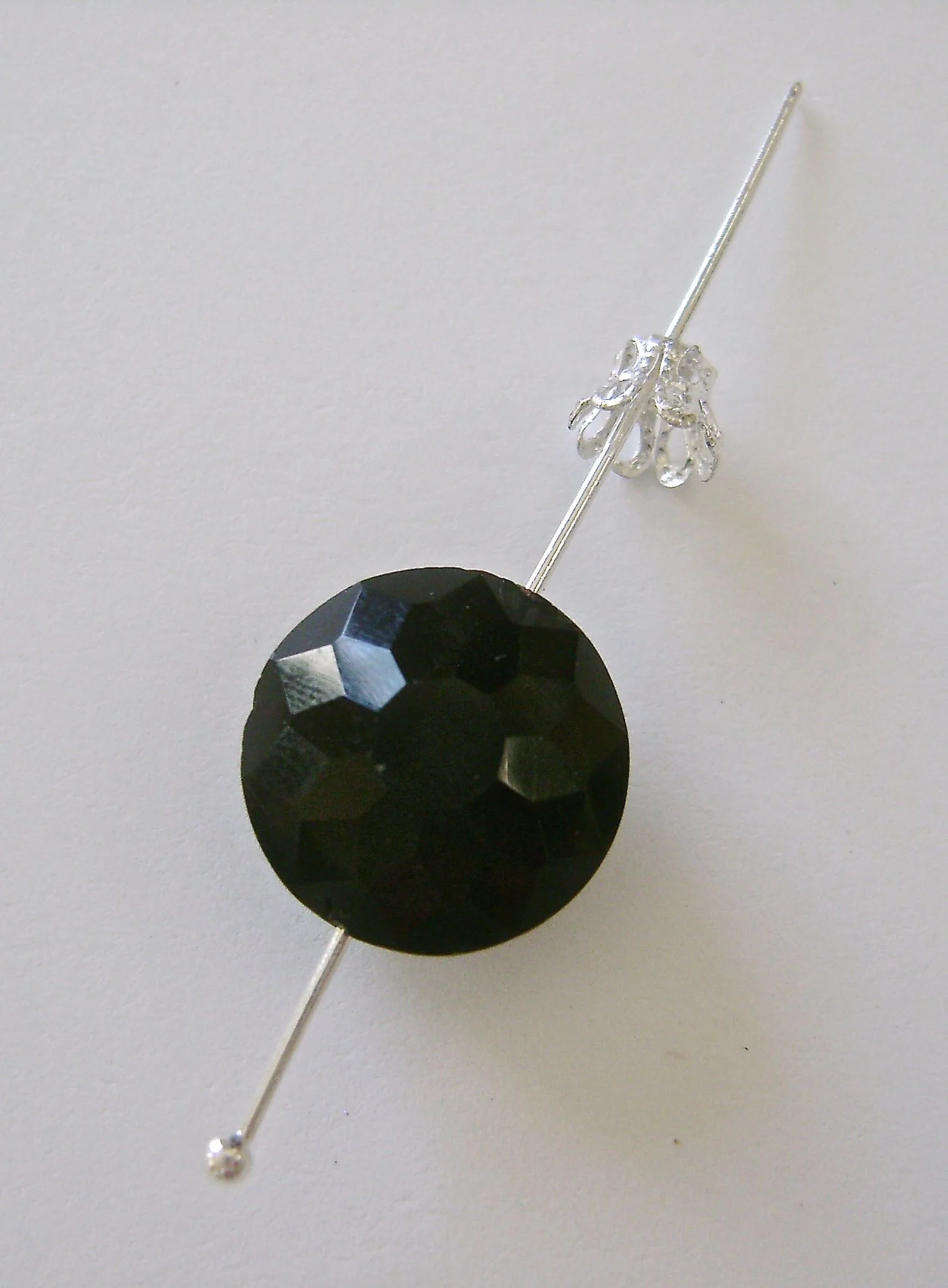 step 1 - Slip a ball tip headpin wire through a bead and a bead cap. Create an eye/loop in the top of the wire and cut away the excess. Create four of these side beads.
