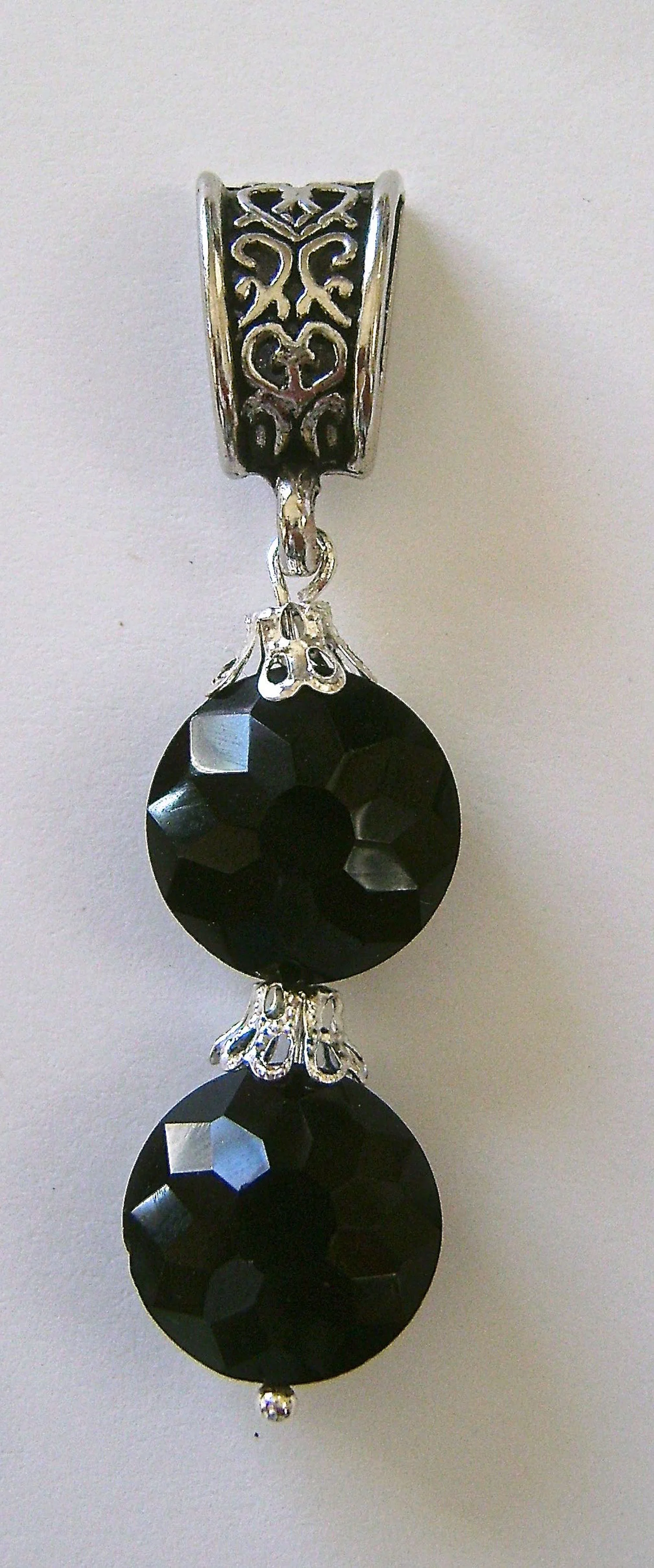 step 3 - Attach the double bead set to the loop in the bail by opening the loop in the wire with pliers. Close the loop.