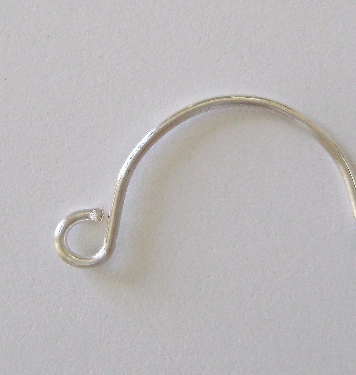 step 5 - Remove the marked wire from the bail. Grasp the mark with round nose pliers and create a loop. Cut away excess.