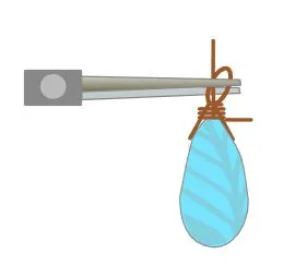 step 7 - Wrap the long wire around the base three times, working toward the bead. Use pliers to straighten the loop.
