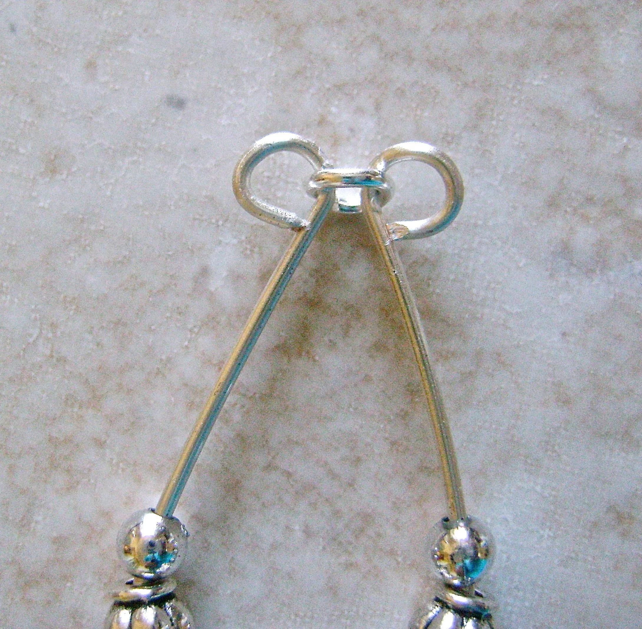 step 6 - Remove the Sharpie marks with alcohol. Bring the two loops together. Open a 5mm jump ring and link it through both loops. Close the ring.