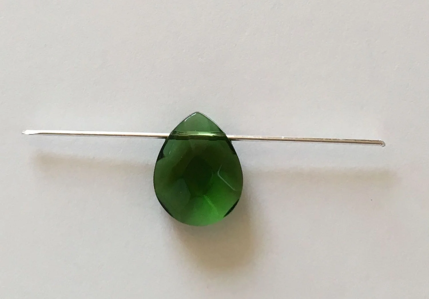 step 1 - Cut two pieces of 18 gauge wire to measure 2” long. Slip the wires into the bead holes. Center the beads on the wires.
