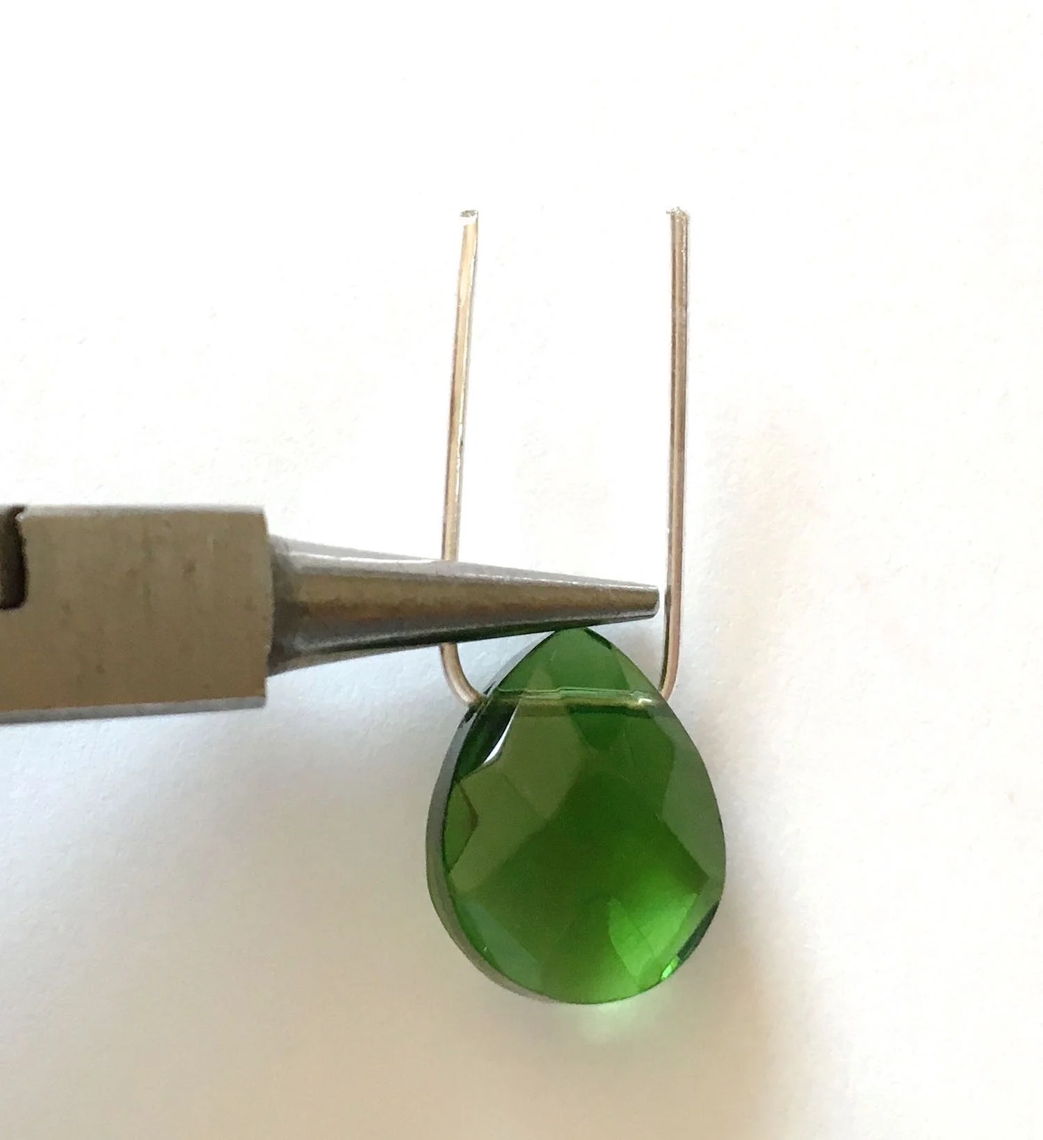step 3 - With the wire grasped in the needle nose pliers, rest the pliers at the top point of the bead.