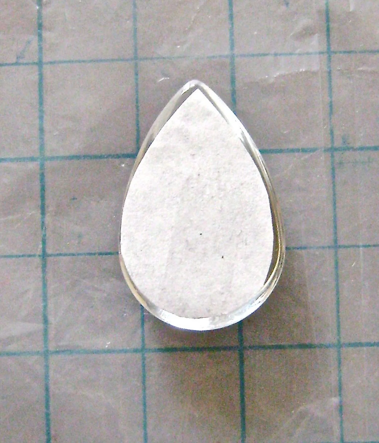 step 9 - With the color side down, set the paper in place on the glass leaving a tiny margin outside the paper edge. Work quickly. Like the name suggests, Fast Finish dries super fast. The good news is, if you make a mistake in placement you can start over. Put the pendant in hot tap water with detergent for a few minutes. The glue and paper will slide right off and you’ll have a clean piece of glass for your next try.