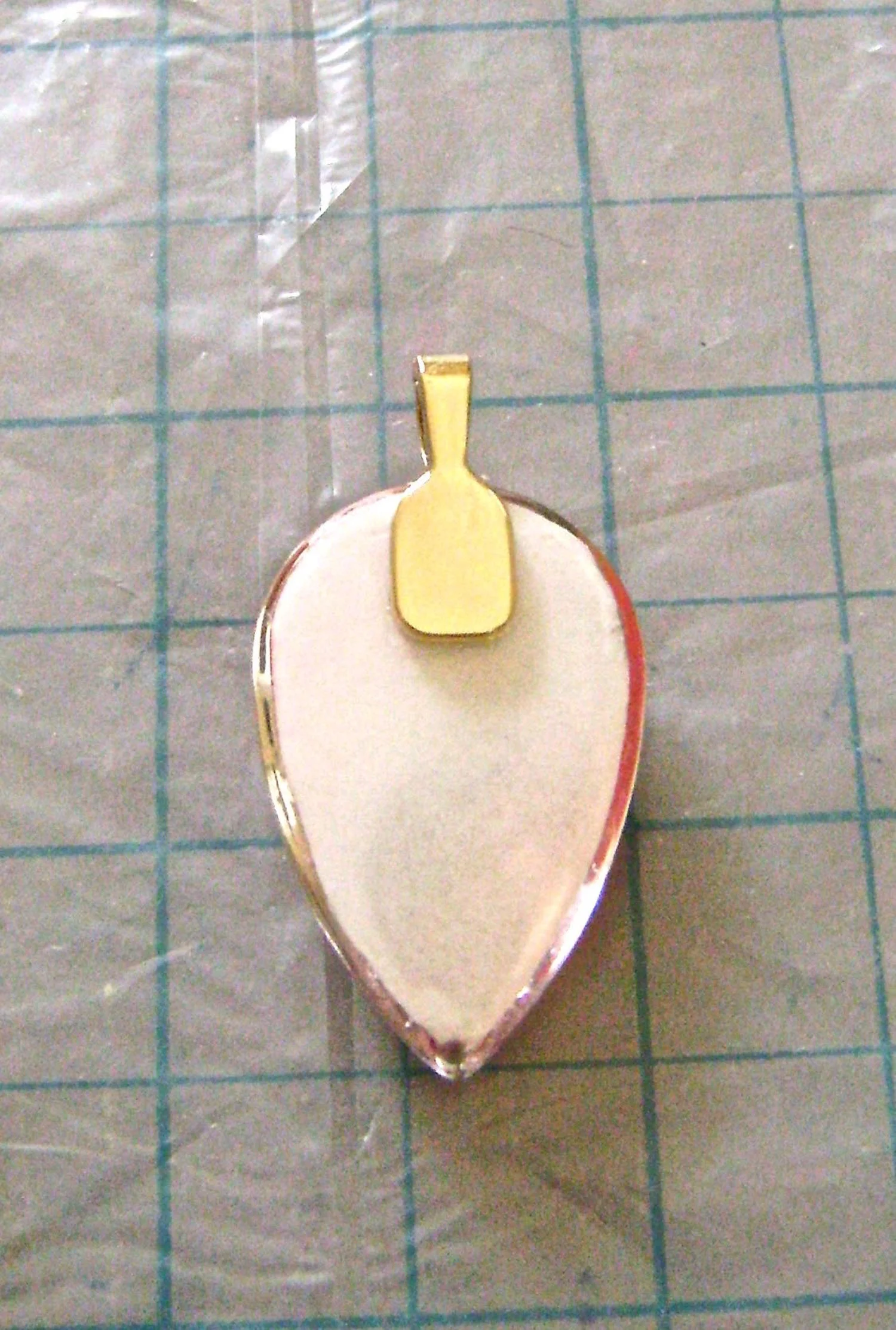 step 13 - Attach a bail to the round end of the teardrop with Dazzle-Tac.