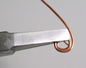 step 3 - Smooth the wire in a circle with your fingers not the pliers. Work in small increments moving the position of the pliers. Follow the shape of the loop. Avoid sharp angles in the wire.