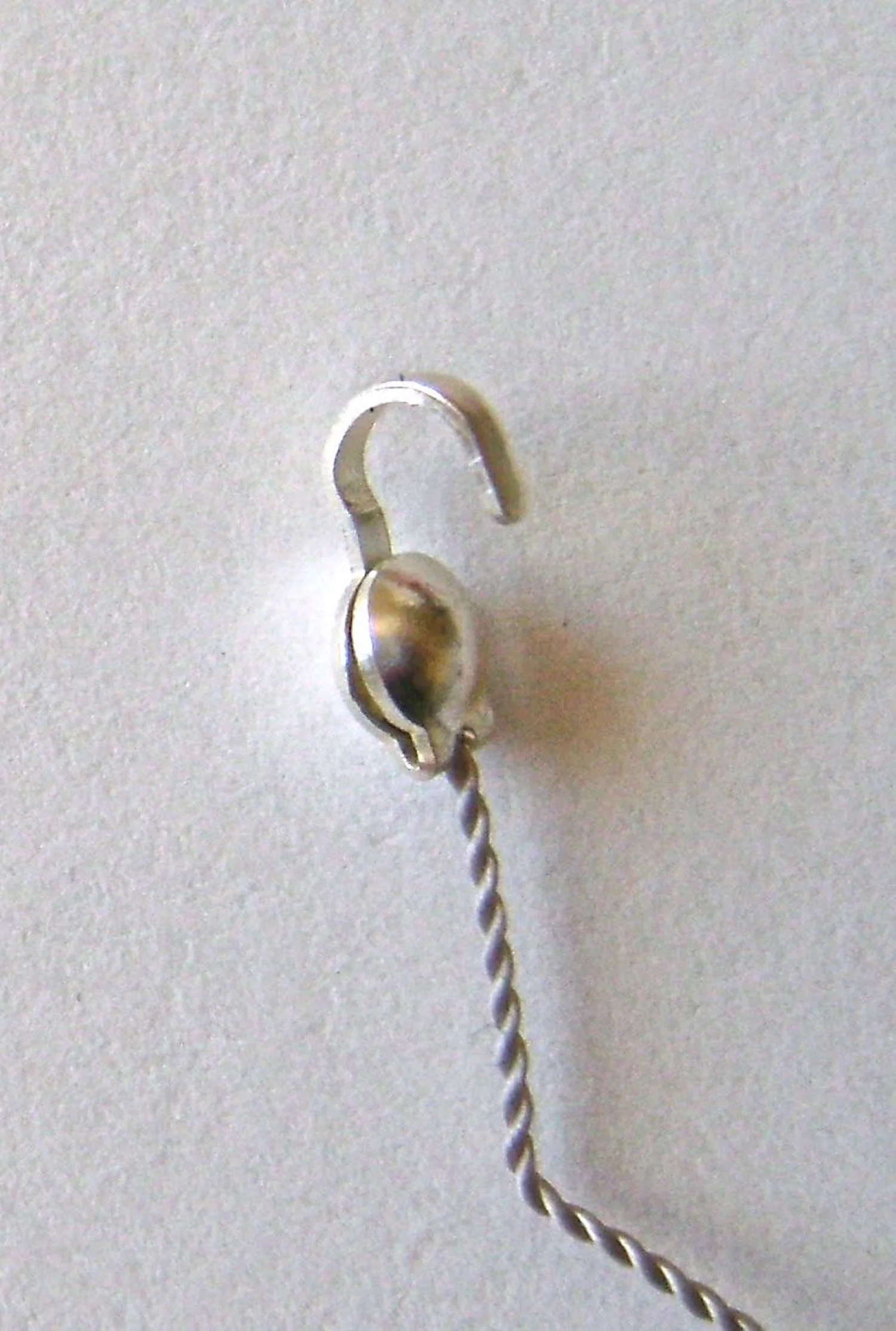 step 2 - Cut off the excess cord and use pliers to close the clam shell.