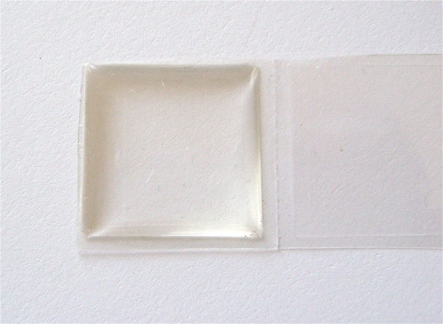step 4 - Peel the adhesive from the plastic. Set it into the frame.