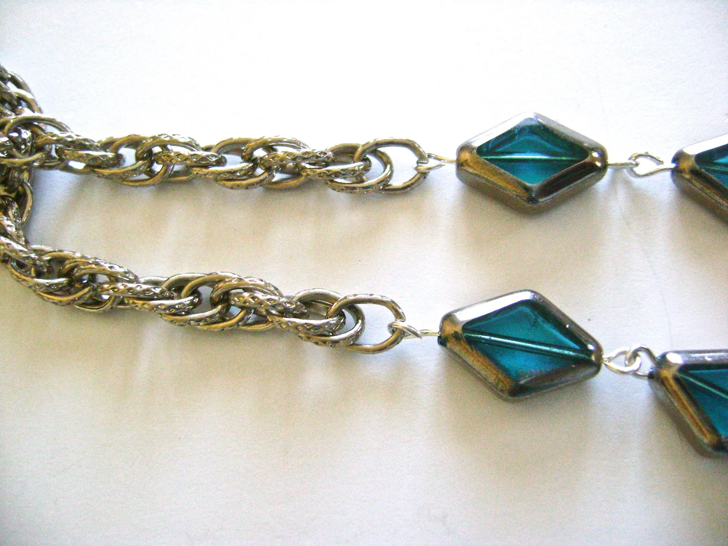 step 5 - Attach the four pieces of chain to the end loops of the small beads. Connect the two chain ends on each side with a link form the chain.