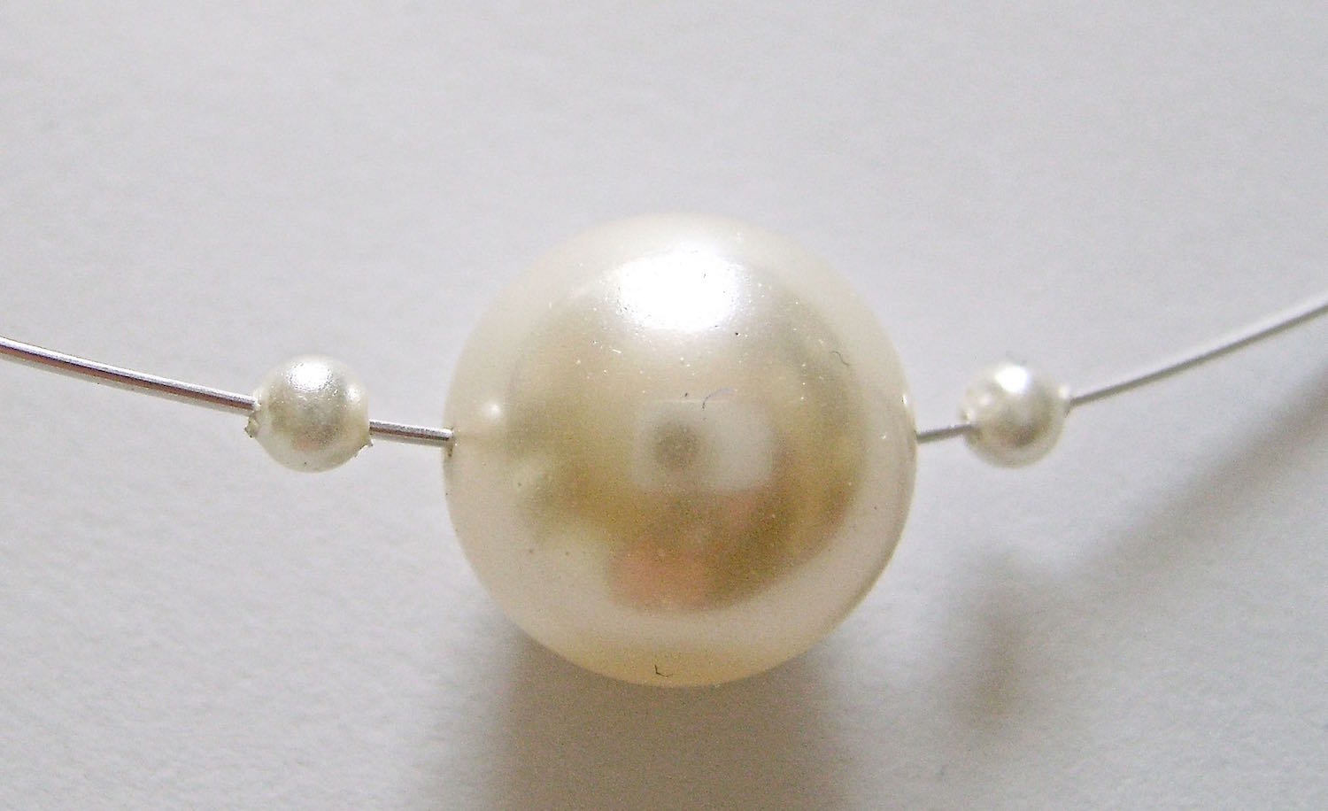 step 6 - Add one seed pearl, the 12mm pearl and another seed pearl to the wire.