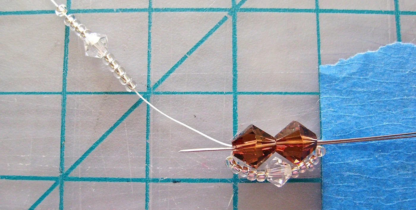 step 4 - Once again, thread on 5 seed beads, a 4MM bead, then 5 more seed beads. Put the needle through the two 6MM beads.