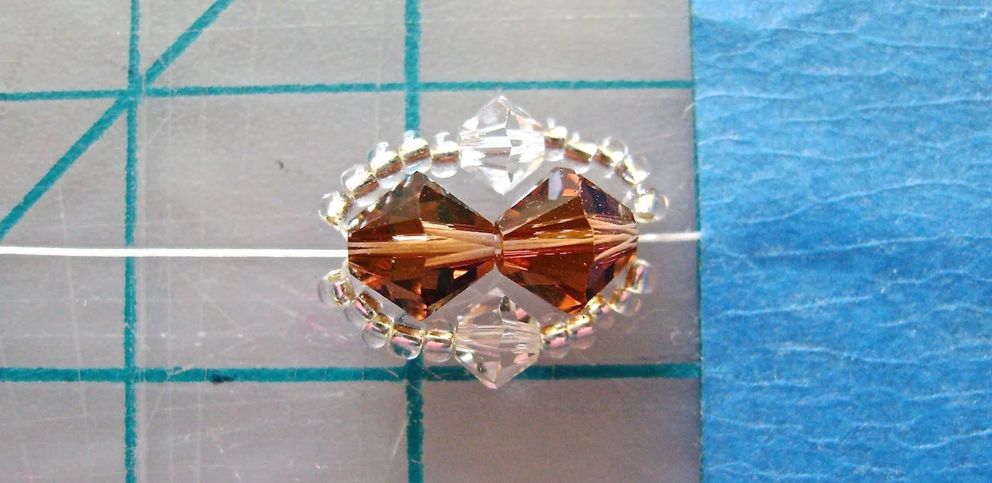 step 5 - Pull through creating a border on the top side of the 6MM beads. You now have one set finished.