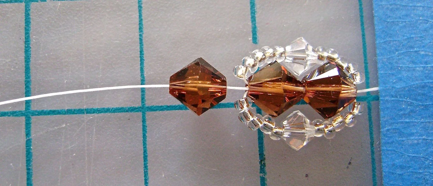 step 6 - Thread the needle through one 6MM bead.