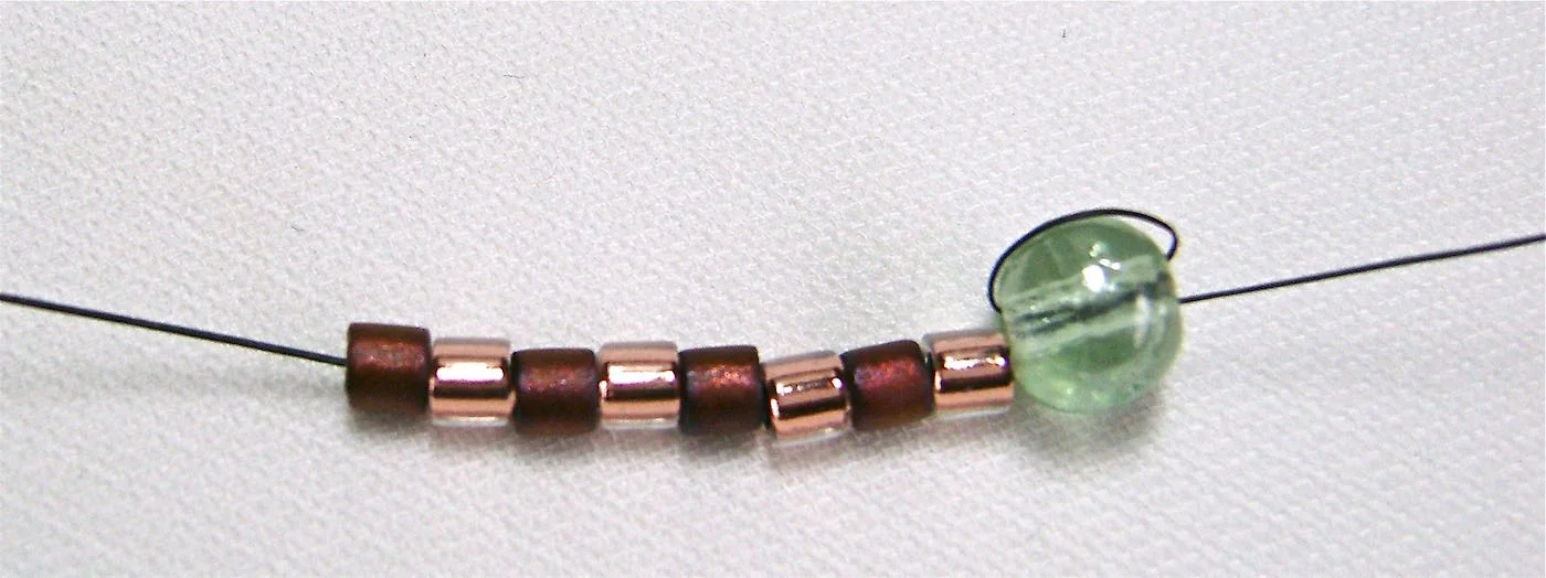 step 2 - String on eight beads, alternating crystal light copper beads with matte dark copper beads. 