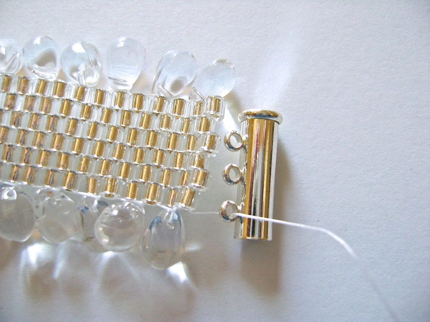 step 1 - Work your needle through beads along the edge until it is aligned opposite a loop. 