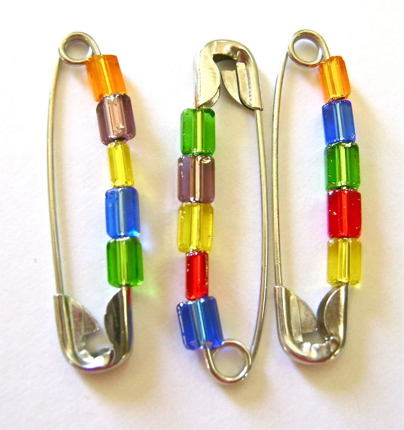 step 2 - Pins will be aligned on the bracelet with opposite ends together so line them up on your work surface that way. Alternate a pin head with a pin tail throughout. Notice the color placement. If you aren’t happy with it, now is the time to make changes. Your first and last pin should be head to tail also.
