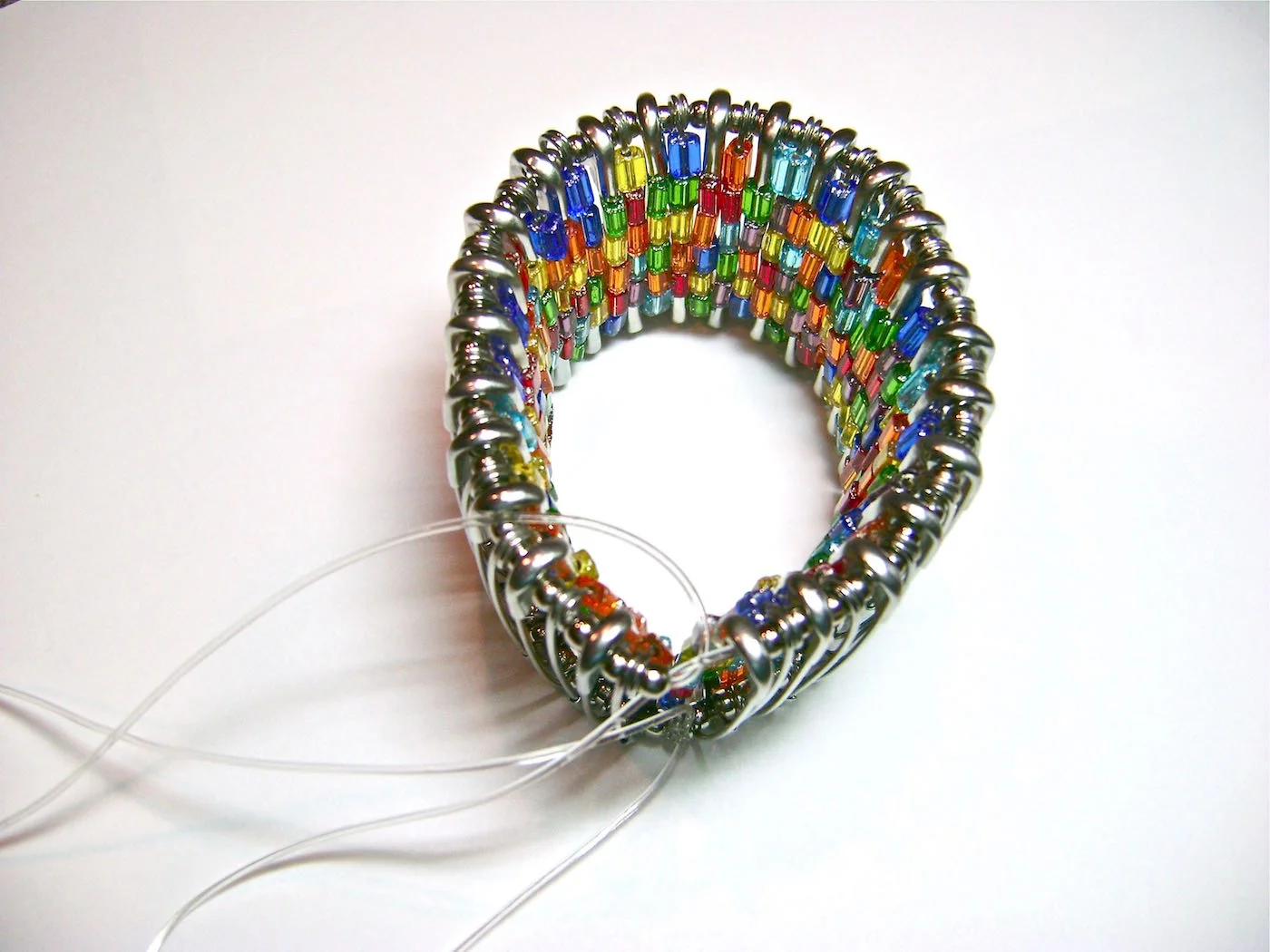 step 5 - Turn your work with the right side against the work surface and tie the ends of the top cords together. 