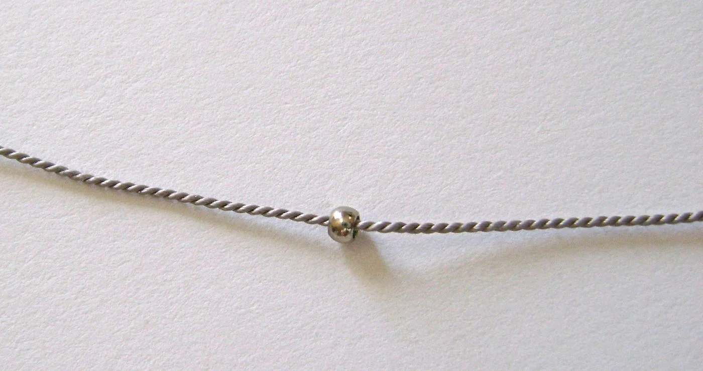 step 1 - Place a crimp bead onto the bead cord.