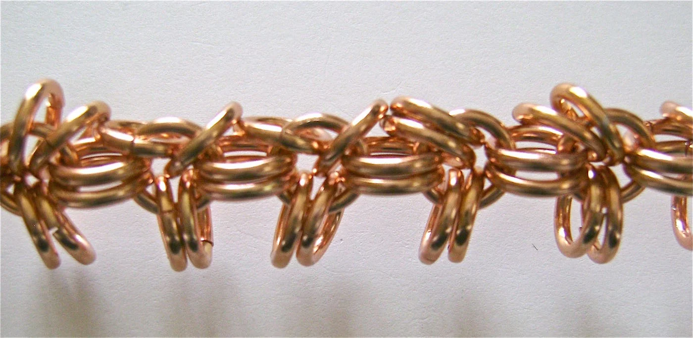 step 2 - Attach two rings on the left and right of every single ring across the entire bracelet.