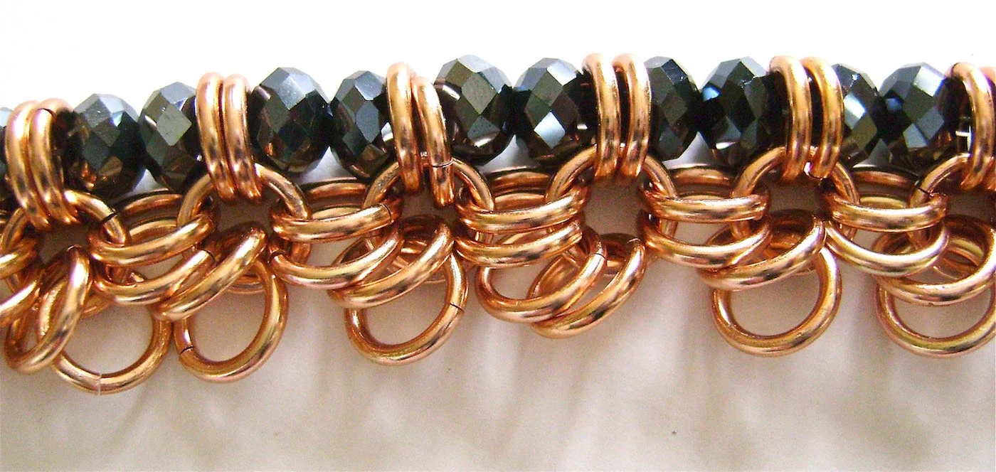 step 5 - Continue Adding two beads and passing the wire through the double rings until you reach the end of the bracelet.