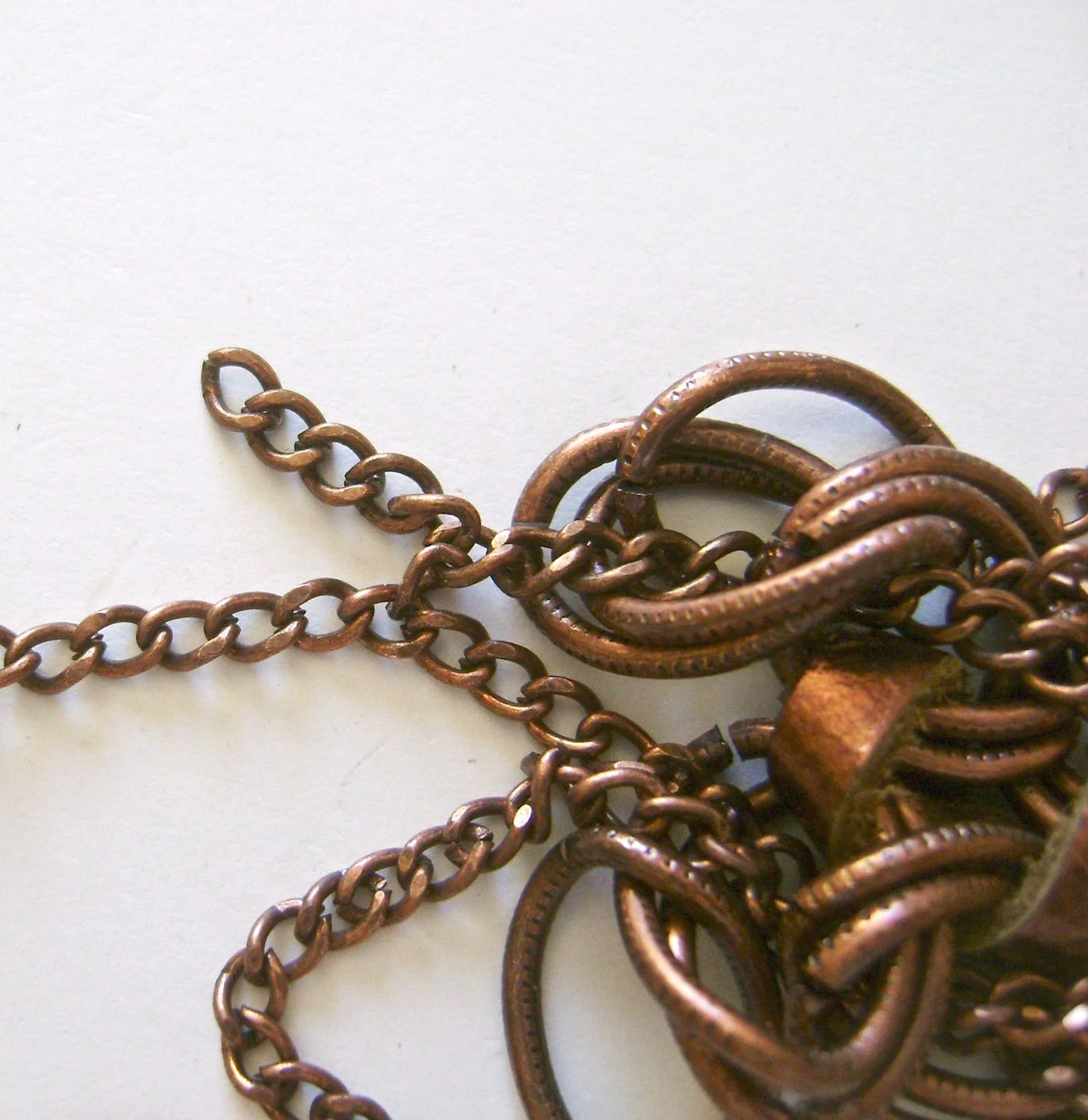 step 8 - When you’re done weaving the chain, open one of the thin links and use it to join one of the end chains to one of the starting chains. 