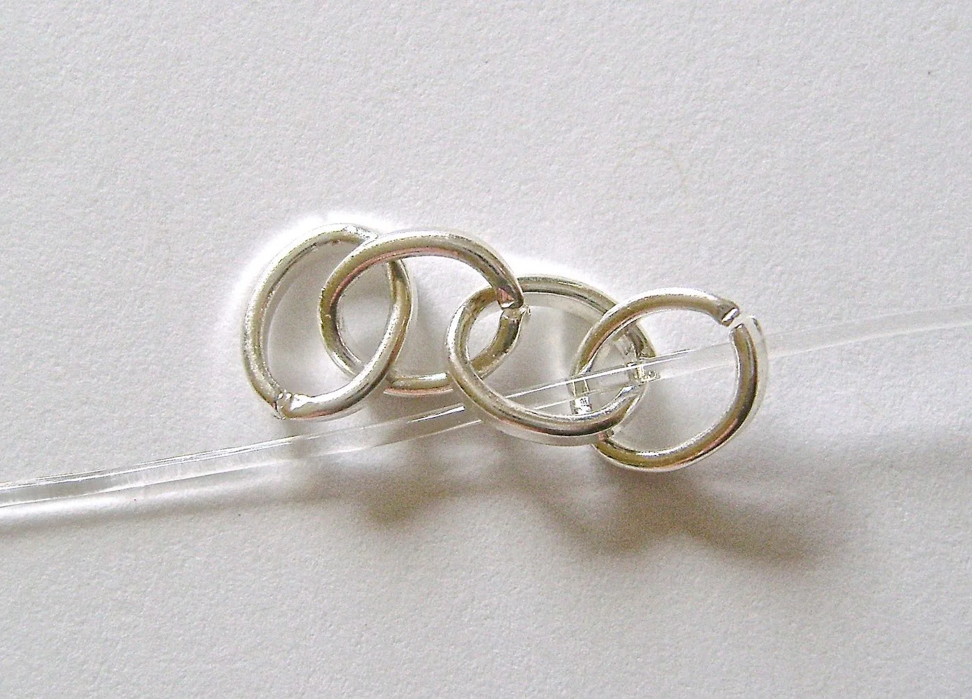step 3 - Pass the cord through two of the links in the first chain piece.