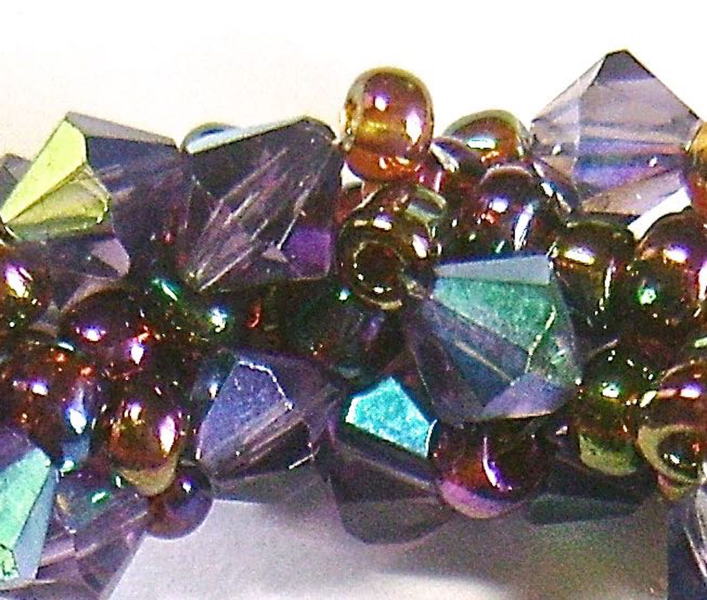 The reflective surface of the Purple Iris seed beads produce a variety of beautiful color variations including red, rust, green and blue.