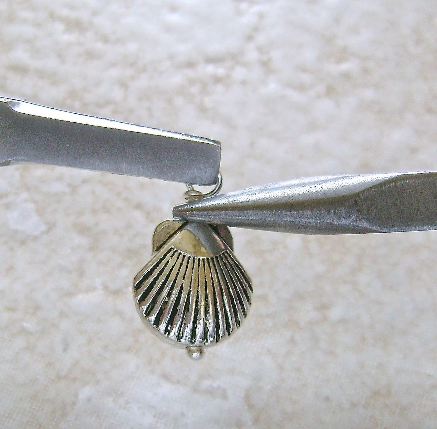 step 5 - Cut away excess wire. Grab the end and gently smooth it around the wrap with needle nose pliers.