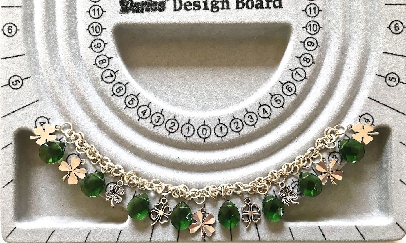 step 2 - Start your placement with a charm in the center of a bead board if you have one. From there work out to one side of the chain alternating beads and charms. Once you know how many pieces are required to complete one side of the chain, you can duplicate it on the other.