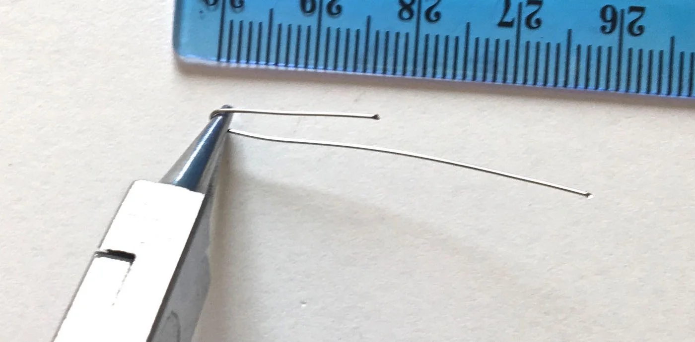 step 5 - With your fingers, turn the wire over the top of the pliers.
