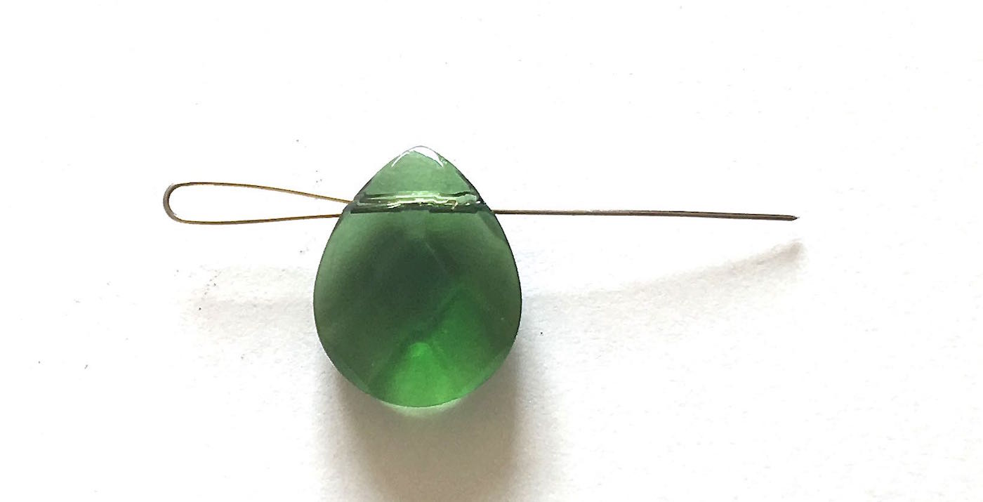 step 6 - Slip the wire into the bead only until the short end of the wire is halfway into the bead hole.