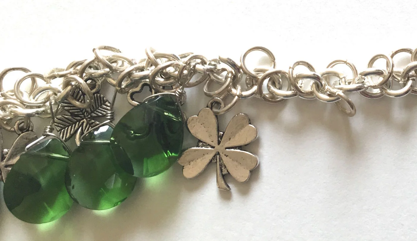 step 11 - Open the chain links between the charms and attach the beads.