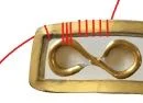 step 2 - Curl the other end of the wire in the opposite direction to form a figure eight. Do the same with all ten wires.