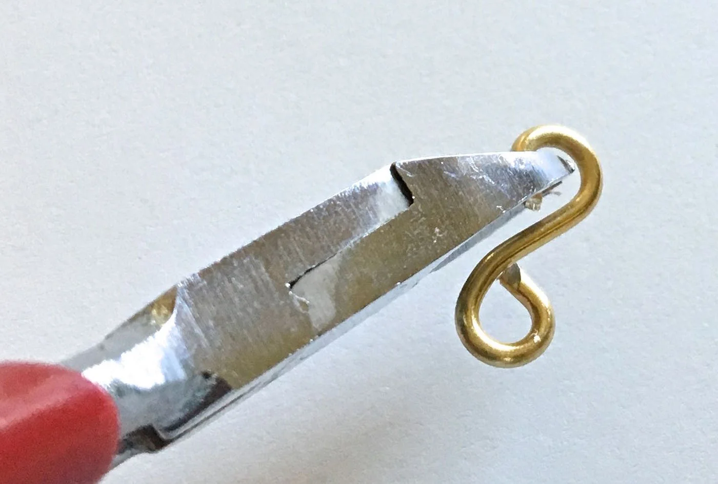 step 8 - Continue working toward the center back of the bracelet on one side. As you move toward the spring hinge, the frame becomes more narrow. Adjust the size of the last three figure eights by clipping off 1/4" from each raw end.