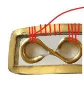 step 11 - Go back to the beginning of your work. Remove the two temporary wraps on the frame. Bring the tail wire to the back of the bracelet and insert it into the wraps. Pull snugly and snip off the excess.