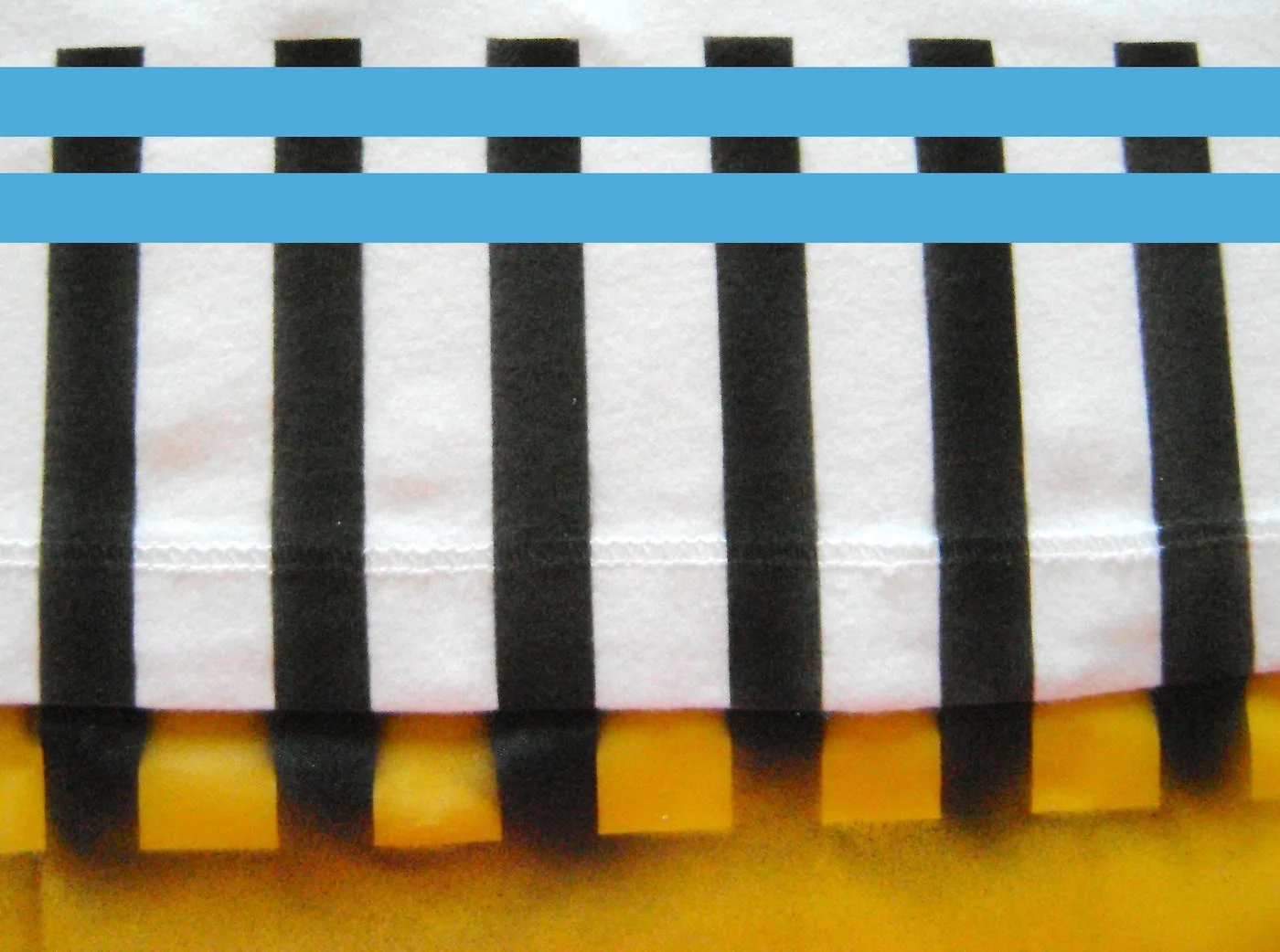 step 8 - When dry, remove the stencil. Place painters tape 1/2” down from the top of the fence posts. Do not press it only lightly so it will not pull up color when you remove it. Place another piece of tape 1/2” away from the first. Spray the space between the two with Black Tie to create the horizontal fence brace. When dry remove the tape.