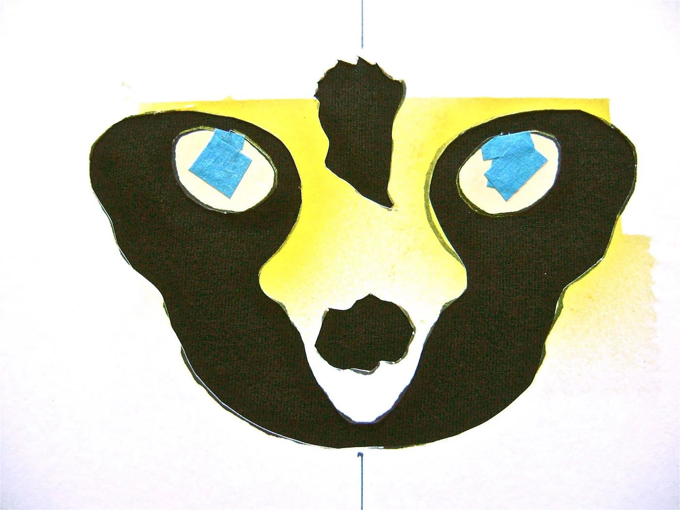 step 5 - Put the stencil back on the shirt along with the taped eyes. Be sure all three pieces are positioned correctly.
