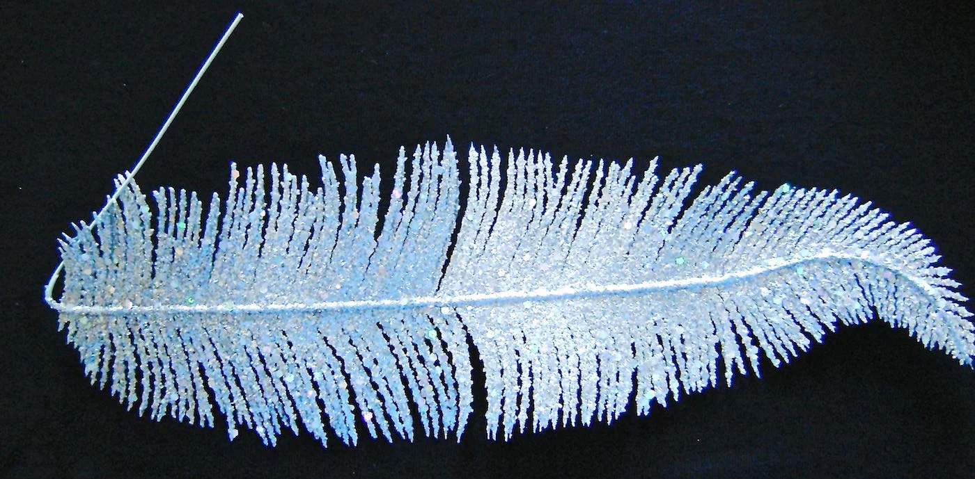 step 6 - Create a hairy look on the face using a plastic feather or similar tool. Apply Malt Shop paint as you work around the face laying the feather down on top of the stencil and spraying through it. Move the feather to another area and spray again. Keep working around the face until you like the effect. Let it dry.