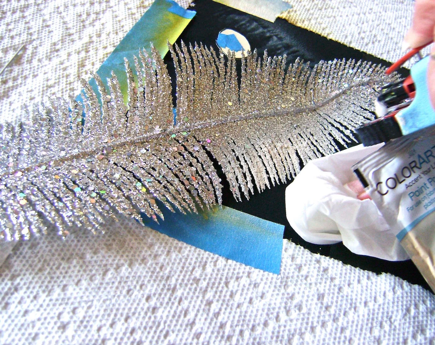 step 8 -Touch up the face by putting the feather only at the the edges of the face line and spraying through it. This will soften the hard edge of the face. Hold the airbrush tool close to the work and a crumpled tissue at the edge of the feather to prevent spraying outside the feather.