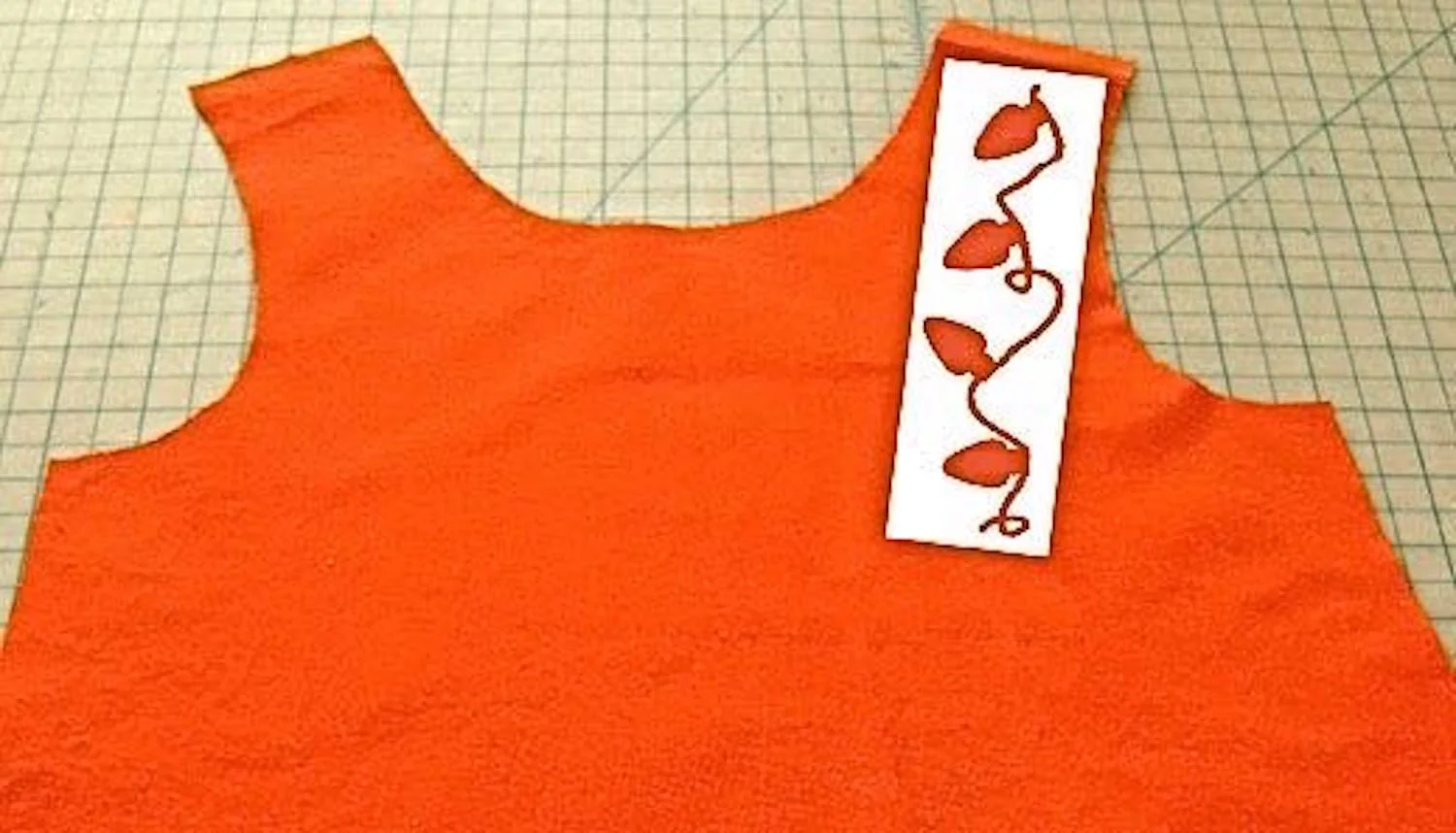 step 4 - Press the stencil onto the front starting at the shoulder seam and angled slightly to the left.