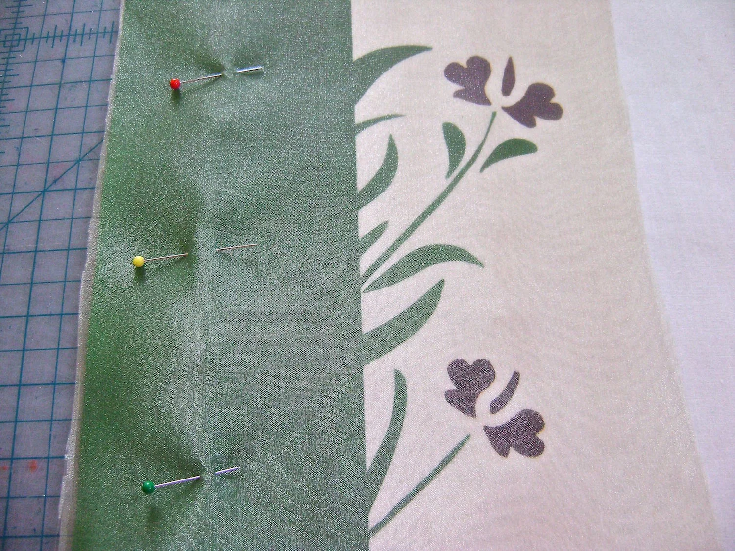 step 10 - Cut a piece of yellow organza to measure 7” x 13.25”. Align the left edge of the organza to the left edge of the pillow front and pin in place.