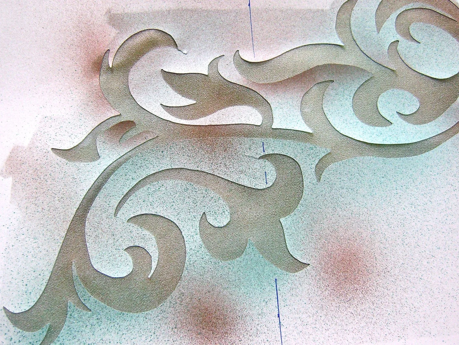 step 7 - Protect the left side of the wrap. Position the filigree stencils as pictured in the sketch. Note that the top half of the wrap and bottom mirror each other so the stencils have to be flipped over to be reused. Spray the stencil with turquoise then dust it lightly in places with brown for accents. Be sure there is no wet paint on the stencil when you flip it. Complete all the filigrees in this way. Let dry completely.