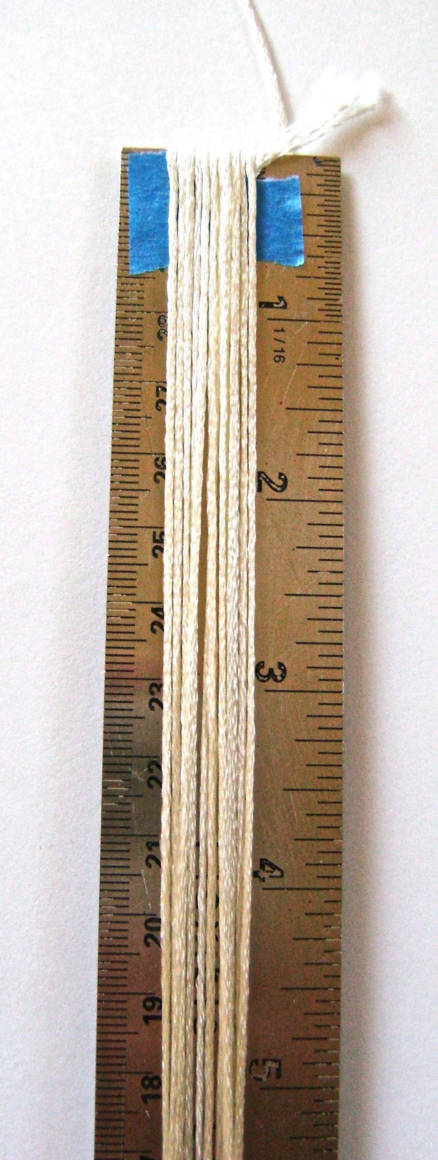 step 1 - The Fringe Cut the floss into 12” pieces. An easy and quick way to do that is to tape one edge of the floss to the end of a ruler. Wrap the floss around vertically. 